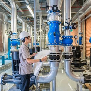 Young,Man,Mechanical,Engineer,Holding,Drawing,To,Checking,And,Inspection